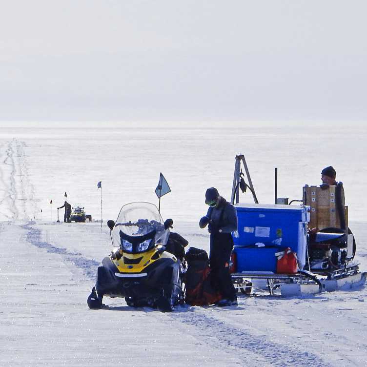 Glaciologists surveying at the grounding zone of Kamb Ice Stream in search of drilling targets that record the history of the ice sheets.